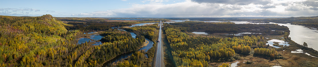 Aerial view of highway surrounded by many bodies of water.